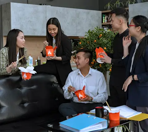 DDfB - Blog - Show Your Team You Care on Employee Appreciation Day - employees in a group eating food