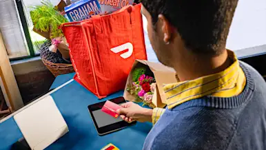 A Dasher paying for a delivery order with their Red Card