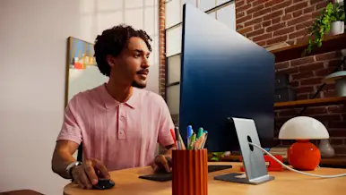 Marchant at a desk using their computer