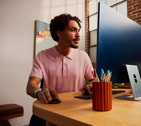 Marchant at a desk using their computer