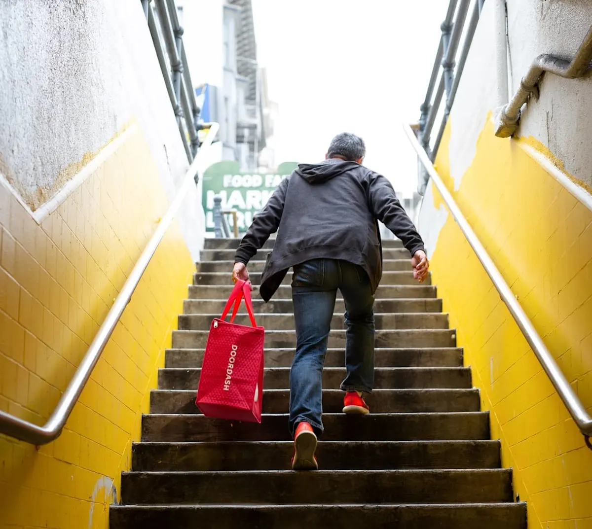 dasher walking up stairs with food