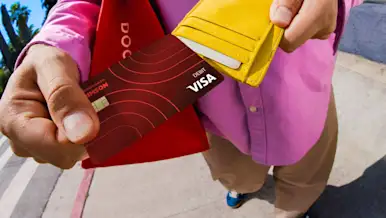 Dasher pulling Crimson card out of wallet
