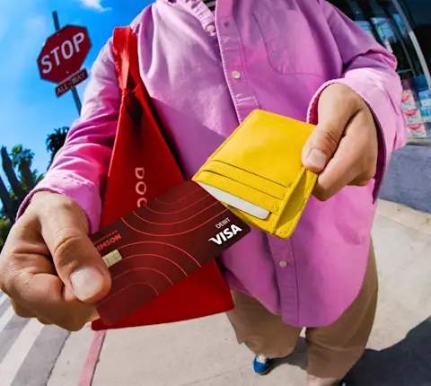 Dasher pulling Crimson card out of wallet