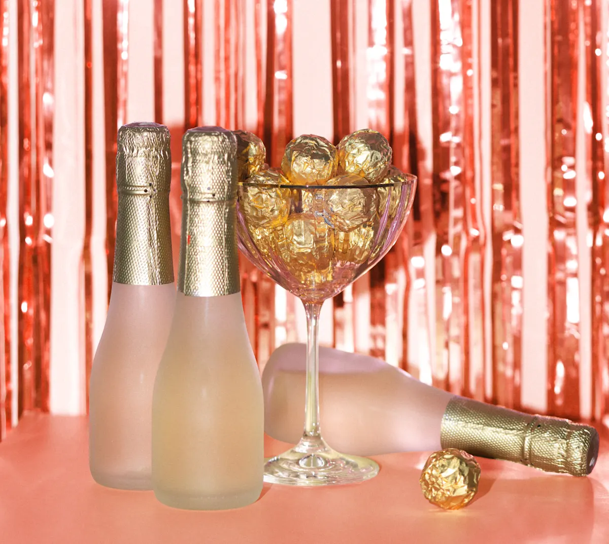 Champagne bottle seated next to chocolate