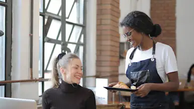 Mx Blog (US) - Why Restaurant Owners Should Be Paying Tips Through Payroll - server with croissant