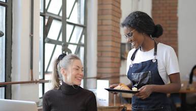 Mx Blog (US) - Why Restaurant Owners Should Be Paying Tips Through Payroll - server with croissant