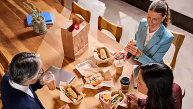 A group of people eating at their office