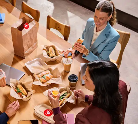 A group of people eating at their office
