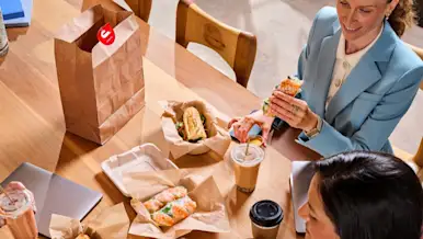 A group of people eating at their office