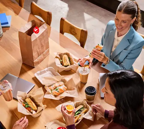 A group of people eating at their office