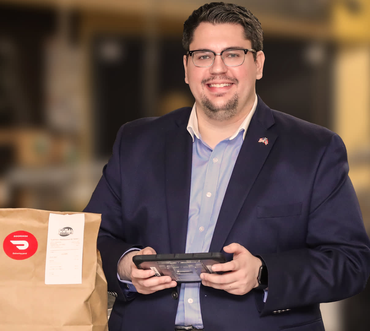 Portrait of restaurateur holding a tablet