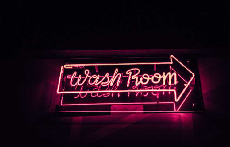 Neon pink wash room sign