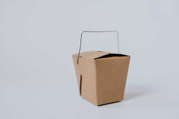Mini takeout container to represent birth control delivery.