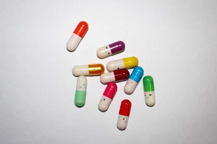 Colorful capsules with smiling faces.