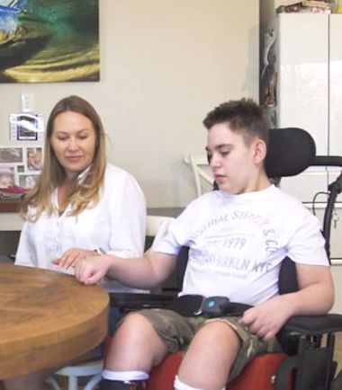 Ethan Allen and his mum sitting at their kitchen table at home Shine Lawyers | Ethan Allen and his mum sitting at their kitchen table at home