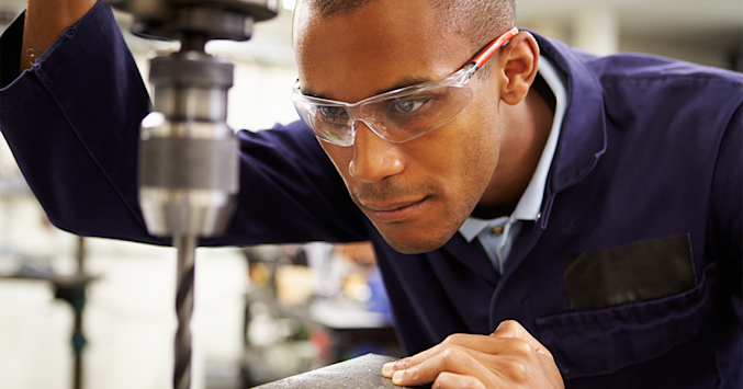 man wearing polycarbonate lenses while working with tools