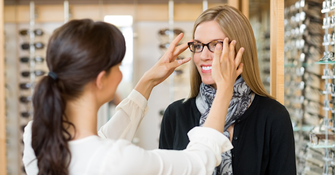 woman being fitted with eyeglasses