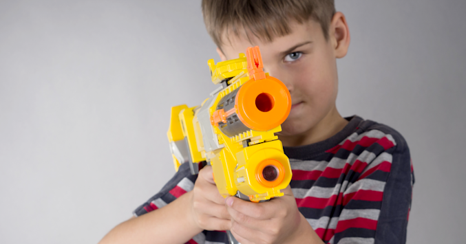 boy with toy dart gun