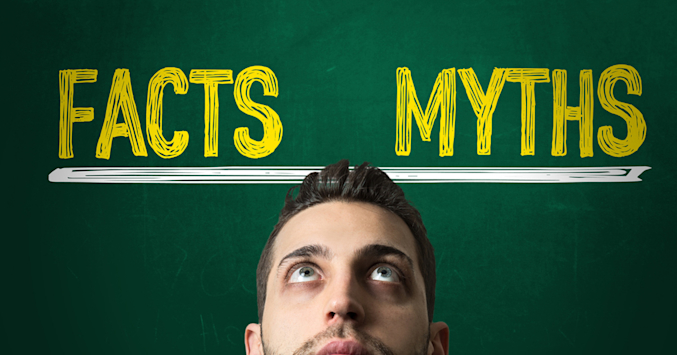 man looks up at board that says facts myths