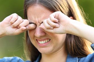 Woman's eyes stinging from sweat