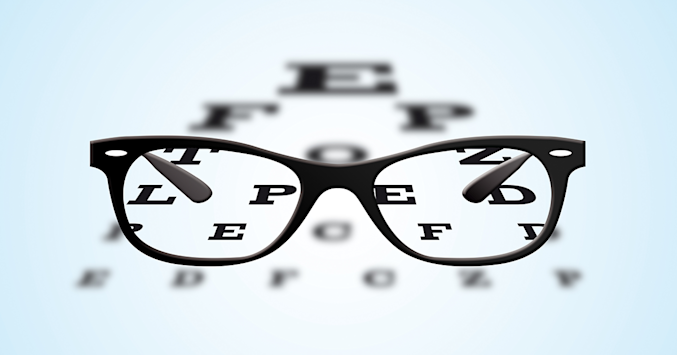 black framed glasses and an eye chart