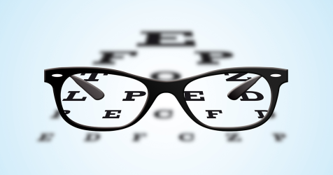 black framed glasses and an eye chart