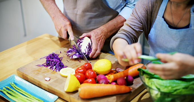 elderly couple making salad