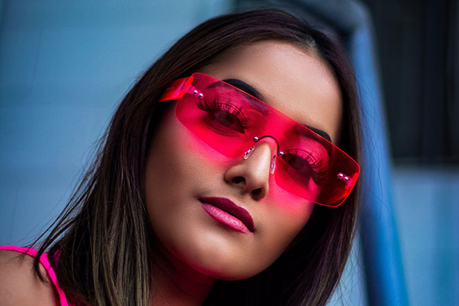 Woman wearing pink rectangular shaped sunglasses