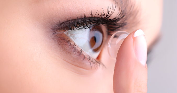 woman applying a contact lens