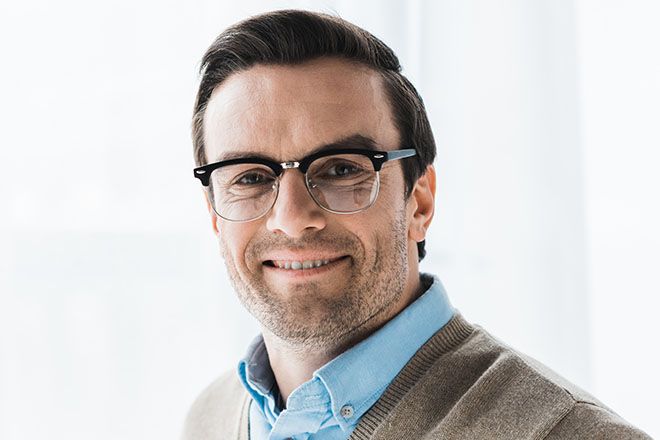Man with a heart shaped face wearing browline eyeglasses