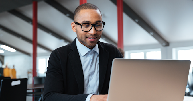 man wearing glasses at computer