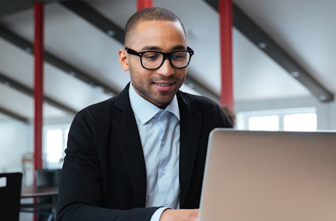 man wearing glasses at computer