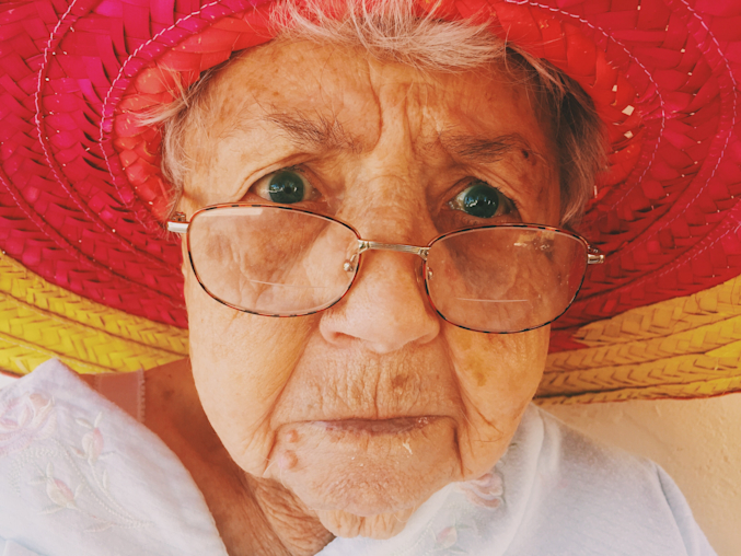 grandmother wearing glasses in big hat
