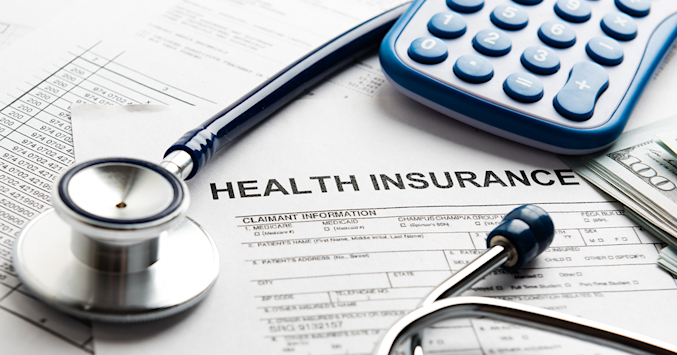 eye surgery bill next to a calculator and stethoscope