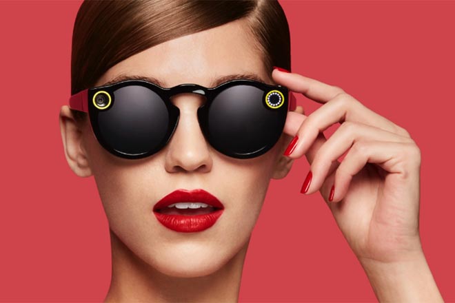 Woman wearing sunglasses with red background