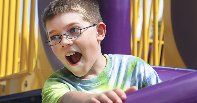 boy wearing polycarbonate lenses while riding a carnival ride