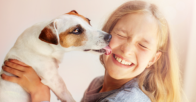 dog licking girls face