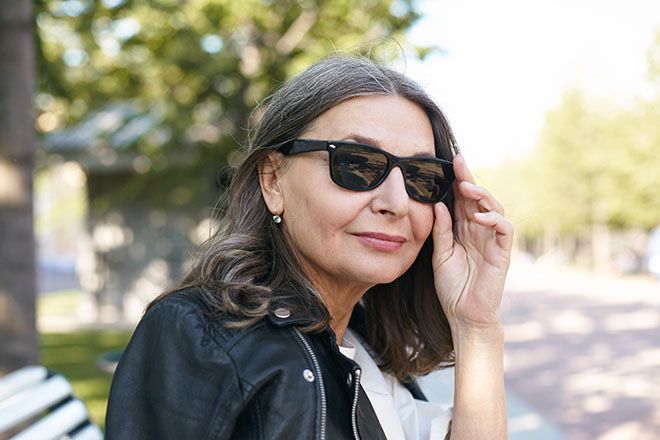 Mature woman wearing wayfarer sunglasses outdoors