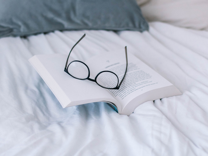 eyeglasses on open book