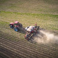 Aerial view of a tractor in the field planting with SIMPAS equipment