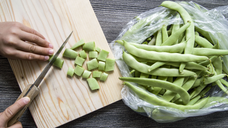 Green beans diced on cutting board