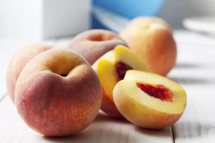 Yellow peaches cut in half