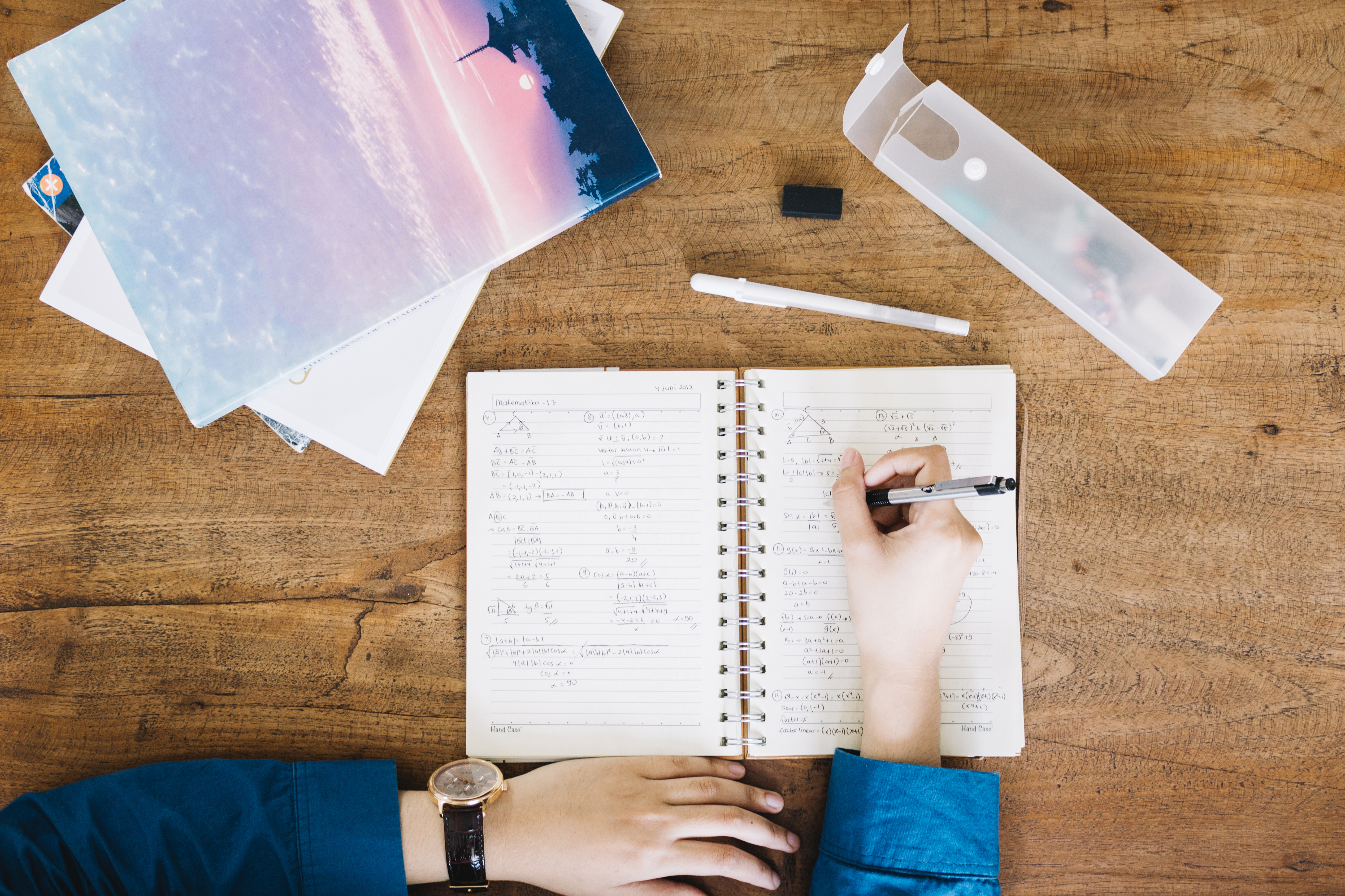 crop-person-writing-notebook