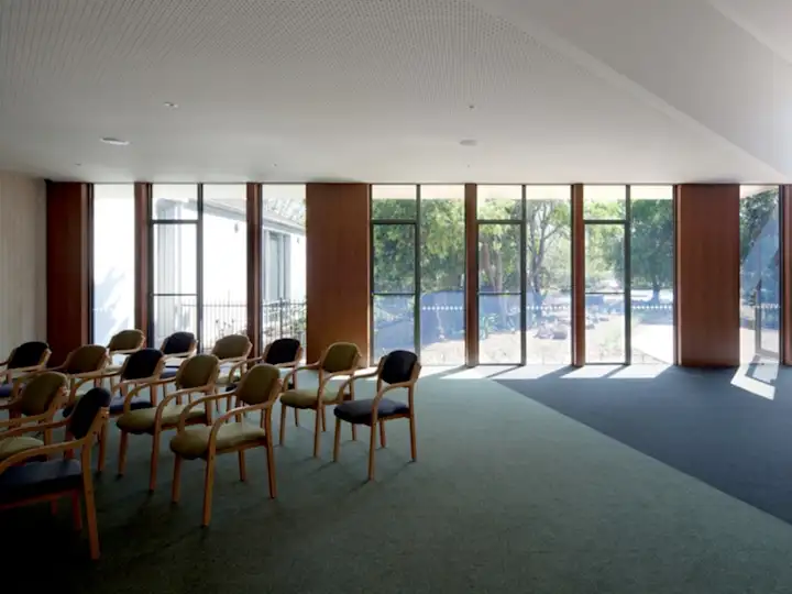 Natural light brightens the reception room, with seating and decorative pendant lights, Altona Memorial Park