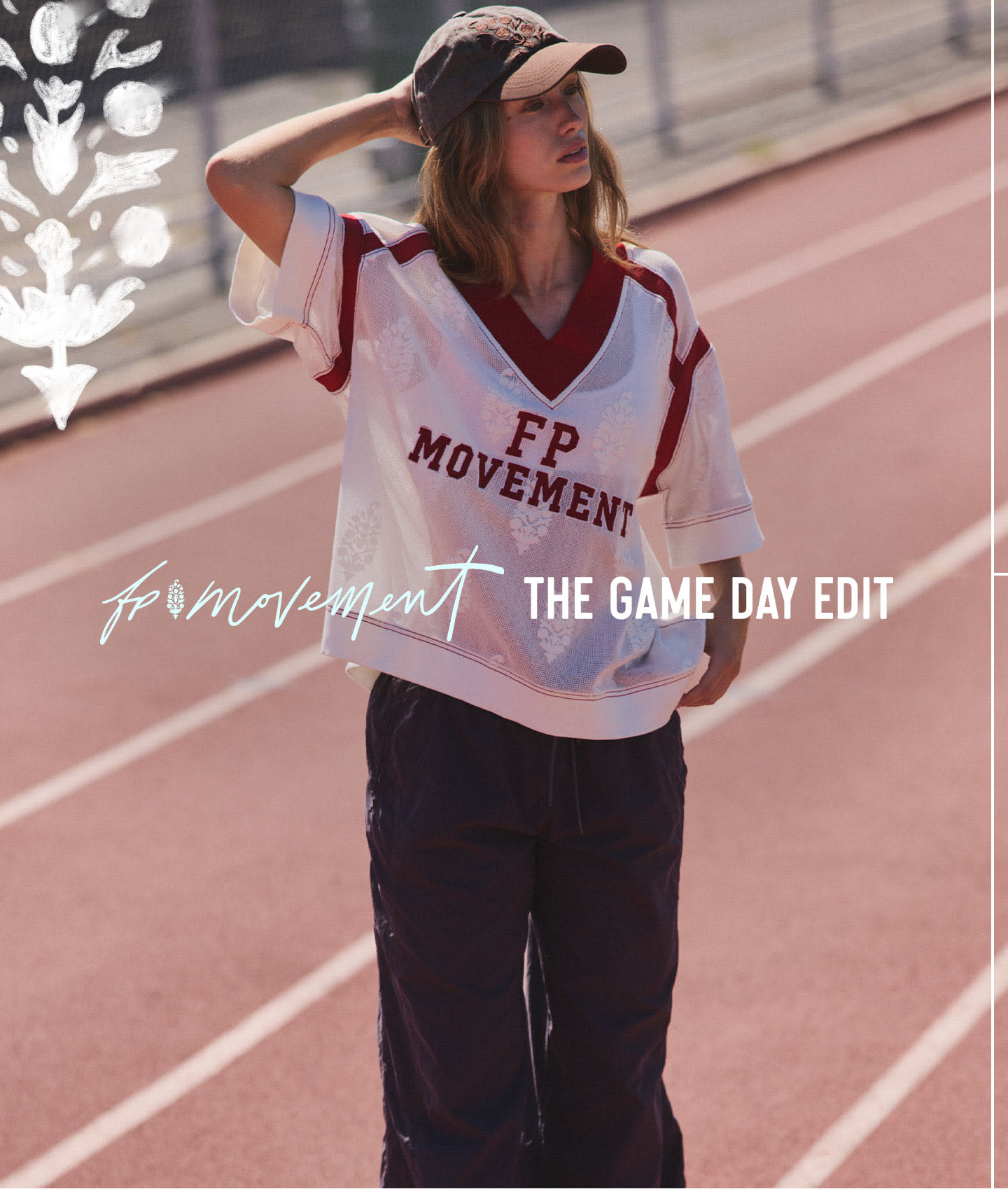 Woman in white and burgundy FP Movement jersey and baseball cap standing on outdoor track with game day edit text overlay.