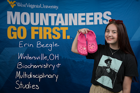 Erin Beegle, a Biochemistry and Multidisciplinary Studies major from Wintersville, OH, holds a pair of pink clogs.