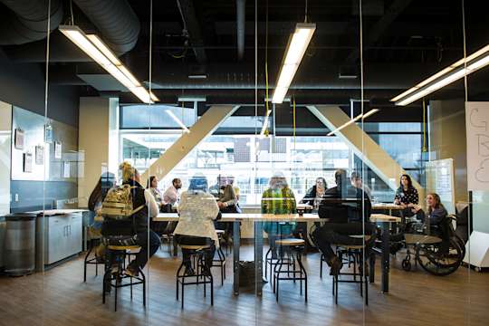 A group meets in the Media Innovation Center