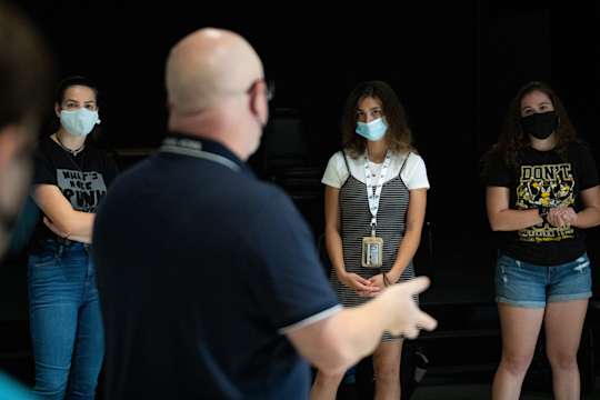Students listen as theatre professor speaks