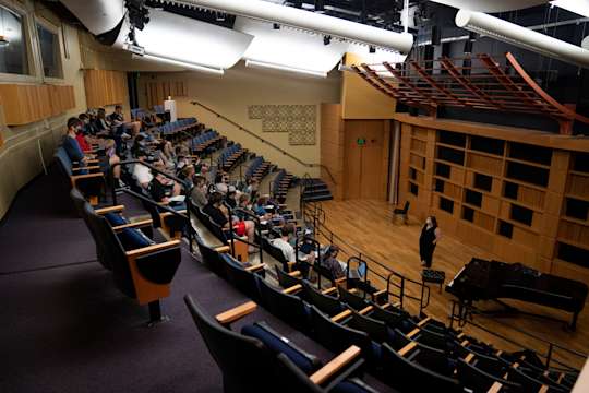 Students listen to a faculty member speak in Bloch Hall at the Canady Creative Arts Center.