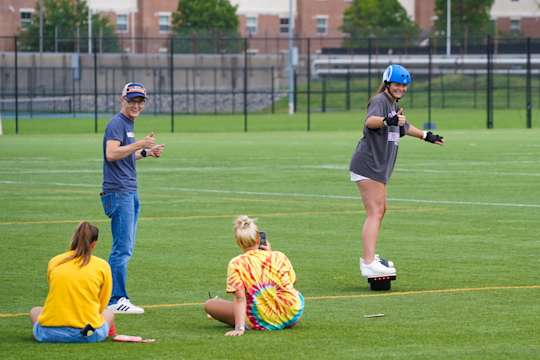 A student gives a thumbs up while trying out a one wheel on the Evansdale Rec Fields.